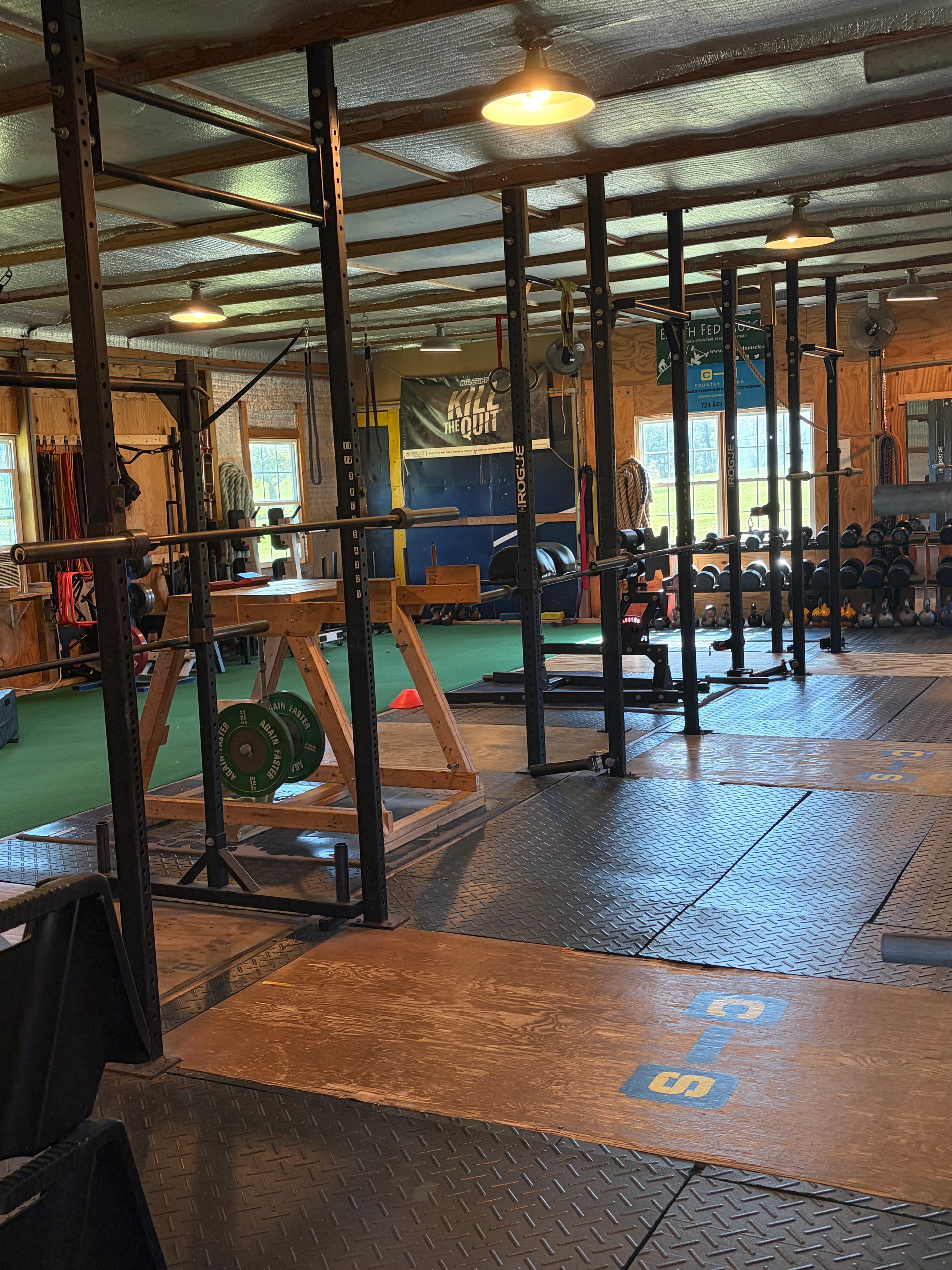 Rogue power racks and professional strength training equipment on the Country Strong gym floor