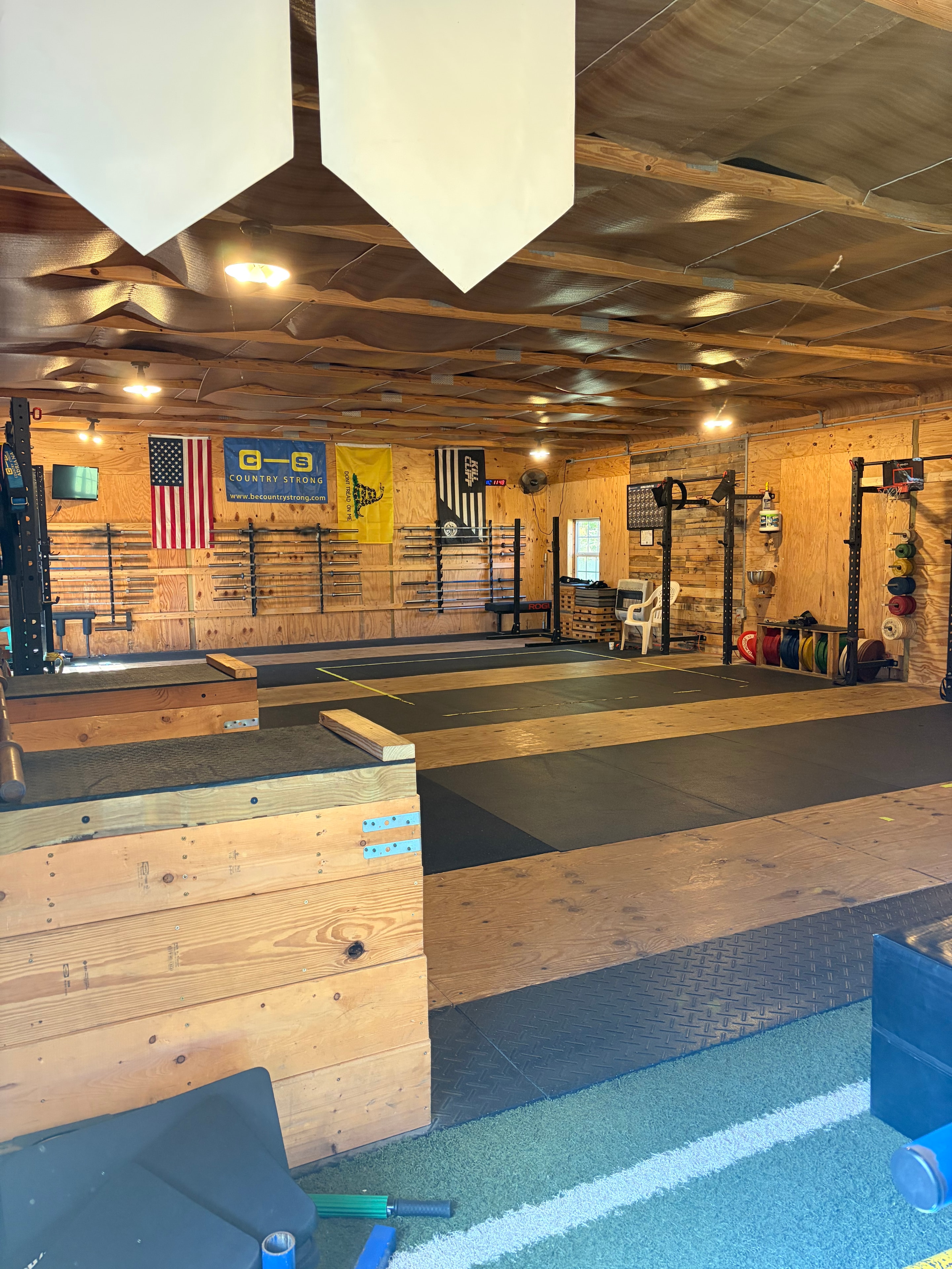 Country Strong gym interior showing the full training floor with American flag and Country Strong banner